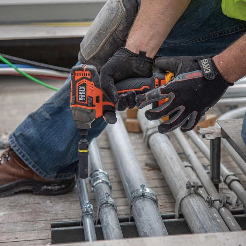 Person using a power drill on metal pipes