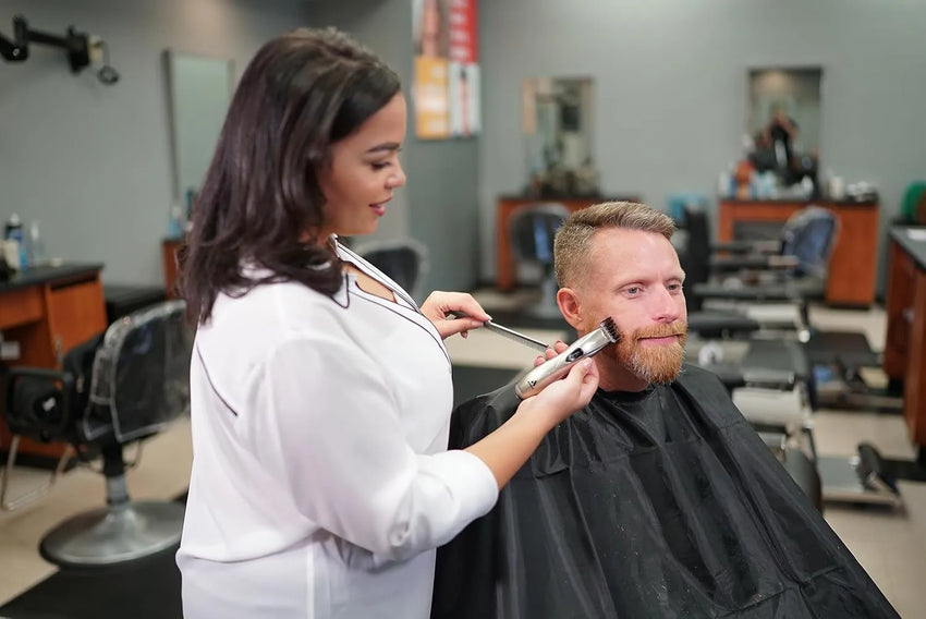 The wizard works with the client's beard using Andis 32810