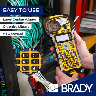 The Brady label printer is held by a person with labeled functions and the BRADY brand name.