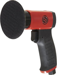 Red and black sander with a black sanding disc on a white background