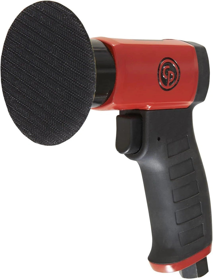 Red and black sander with a black sanding disc on a white background