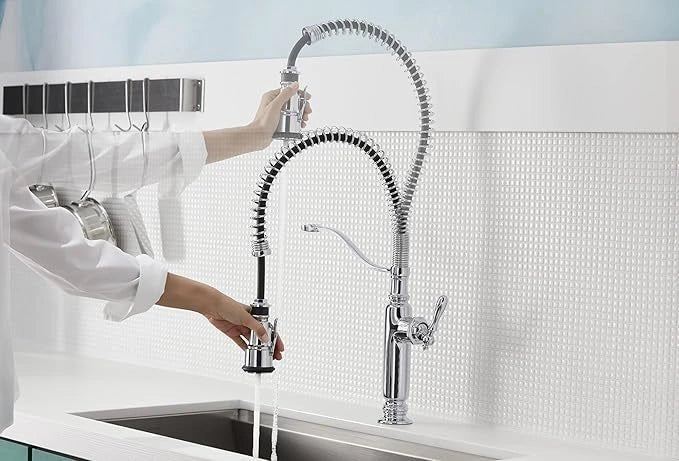 Person using a modern kitchen faucet with a flexible hose in a kitchen setting.