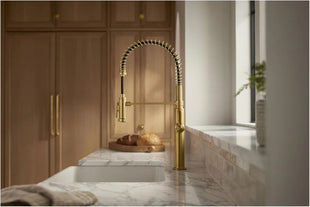 Modern kitchen with a faucet over a marble sink.