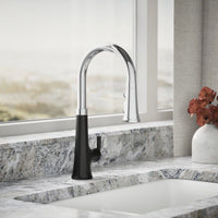 Modern kitchen faucet with black handle on a marble countertop