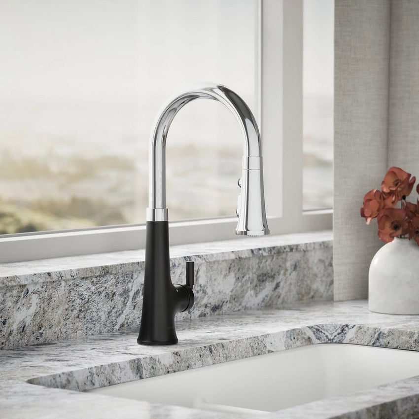 Modern kitchen faucet with black handle on a marble countertop