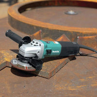 Makita angle grinder on a rusted metal surface